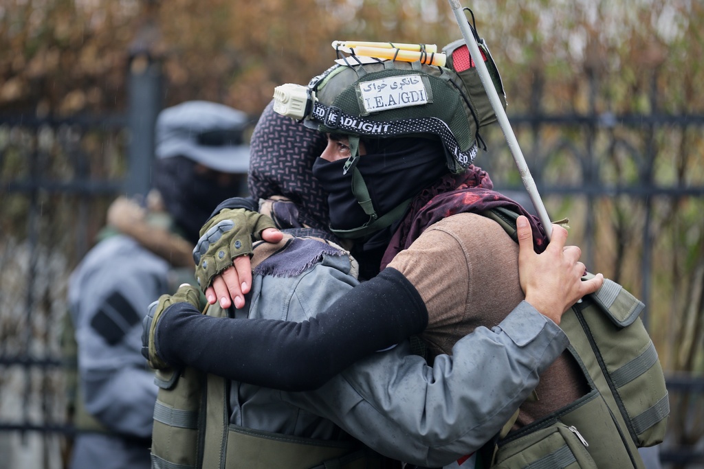 Taliban policemen, left, and a GDI ( General Directorate of Intelligence ) officer greet each other for Eid al-Fitr outside the Shah-Do Shamshira Mosque before Eid prayers in Kabul, Afghanistan, Thursday, March 19, 2026. (AP Photo/Siddiqullah Alizai)