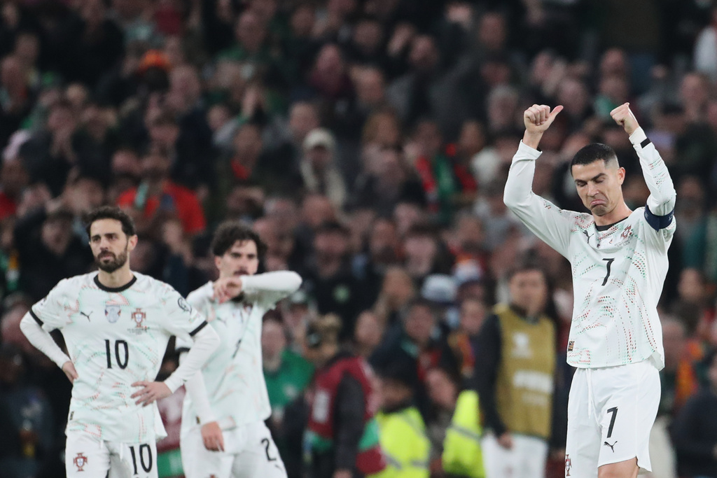 Portugal's Cristiano Ronaldo, right, leaves the pitch after being shown a red card during a World Cup 2026 group F qualifying soccer match between Ireland and Portugal in Dublin, Thursday, Nov. 13, 2025. (AP Photo/Peter Morrison)