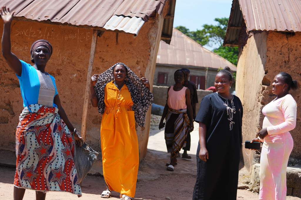 A woman and others who were kidnapped during a church service in November 2024 waves outside her house in Kaduna, northwestern Nigeria, Nov. 6, 2025. (AP Photo/Sunday Alamba)