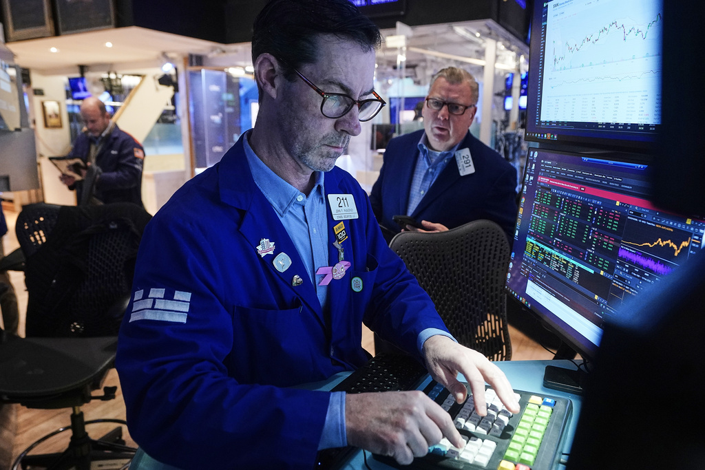 Specialist John McNierney, center, and trader Mathias Roberts, right, work on the floor of the New York Stock Exchange, Tuesday, Feb. 10, 2026. (AP Photo/Richard Drew)