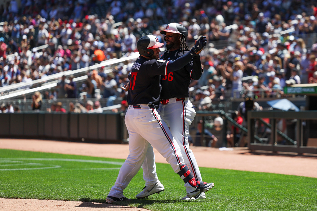 Minnesota Twins' Victor Caratini, left, and Josh Bell, right, celebrate after scoring off Caratini's home run during the fourth inning of a baseball game against the St. Louis Cardinals, Sunday, June 14, 2026, in Minneapolis. (AP Photo/Ellen Schmidt)