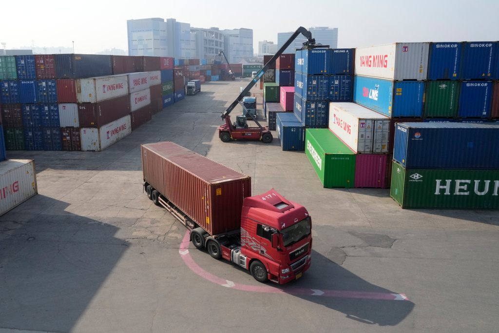 A truck runs by containers at the Uiwang ICD Terminal in Uiwang, South Korea, Thursday, March 12, 2026. (AP Photo/Ahn Young-joon)