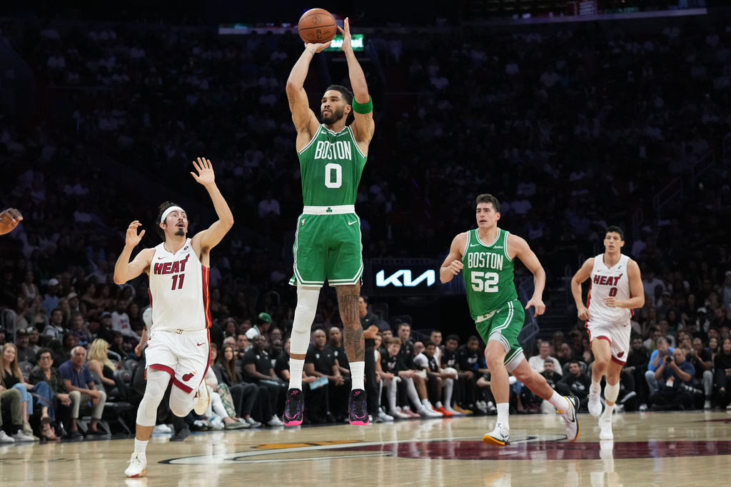 Boston Celtics forward Jayson Tatum (0) shoots a three-pointer during the first half of an NBA basketball game against the Miami Heat, Wednesday, April 1, 2026, in Miami. (AP Photo/Lynne Sladky)