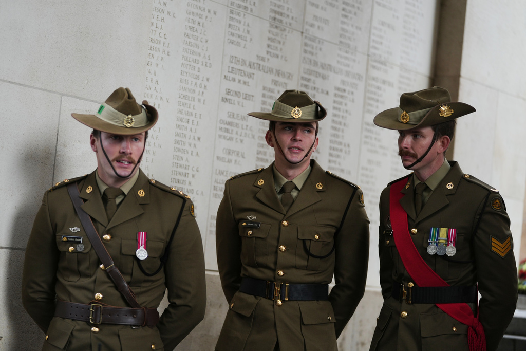 Three Australian soldiers stand next to names of World War I missing during an Armistice Day ceremony at the Menin Gate Memorial to the Missing in Ypres, Belgium, Tuesday, Nov. 11, 2025. (AP Photo/Virginia Mayo)