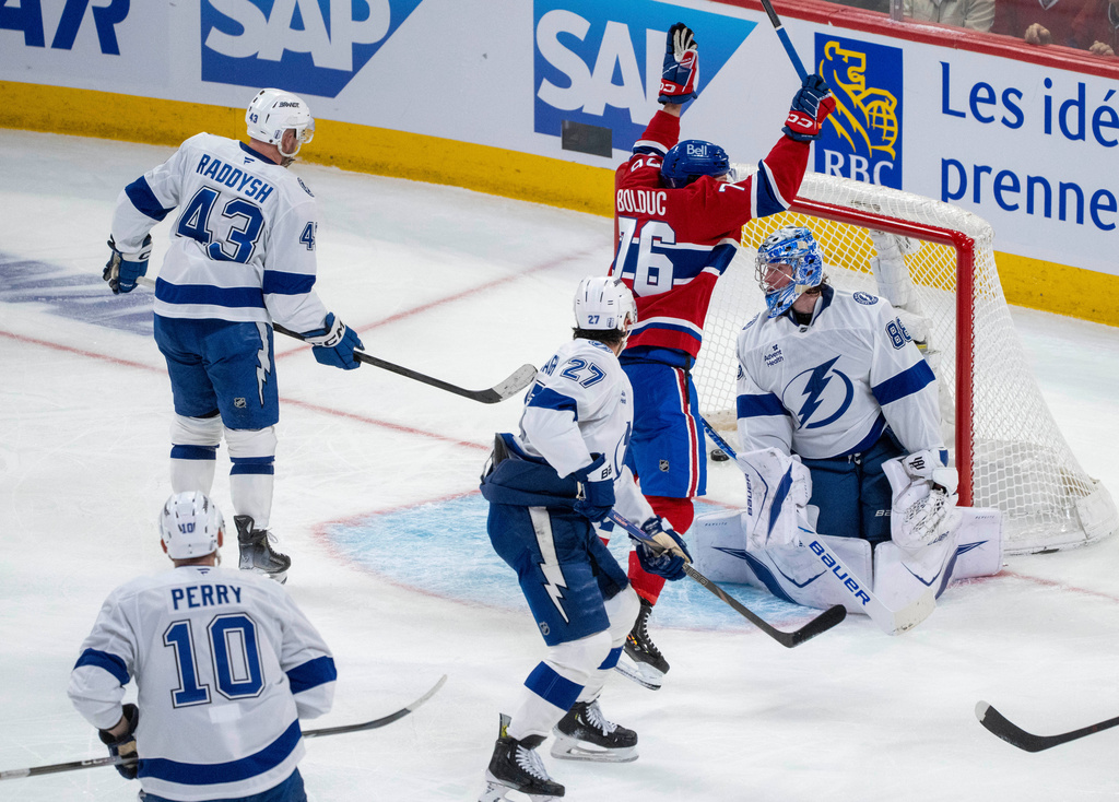 Montreal Canadiens' Zachary Bolduc (76) celebrates after a goal by teammate Kirby Dach (not shown) against Tampa Bay Lightning goaltender Andrei Vasilevskiy, right, during the second period of Game 3 in a first-round NHL hockey Stanley Cup playoff series in Montreal, Friday, April 24, 2026. (Christinne Muschi/The Canadian Press via AP)