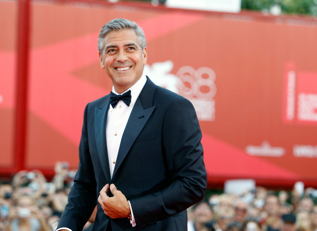 FILE - George Clooney poses on the red carpet at the premiere of his film "The Ides of March," opening the 68th edition of the Venice Film Festival in Venice, Italy on Aug. 31, 2011. (AP Photo/Andrew Medechini, File)