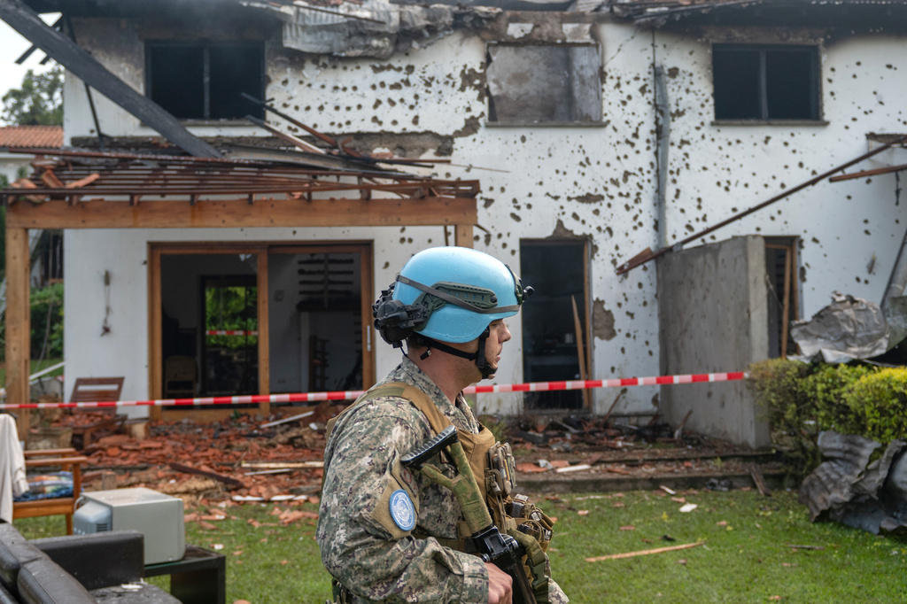 A U.N peacekeeper guards a house hit by a drone strike in Goma, Democratic Republic of Congo, Wednesday, March 11, 2026. (AP Photo/Moses Sawasawa)