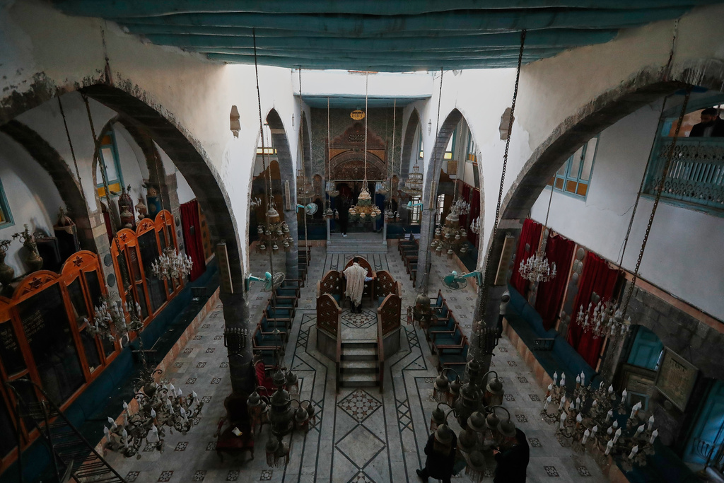 Henry Hamra, centre, a Syrian-American Jew who is one of the founders of a new Jewish heritage initiative, prays at al-Firenj Synagogue in the old city of Damascus, Syria, Wednesday, Dec. 10, 2025.(AP Photo/Omar Sanadiki)