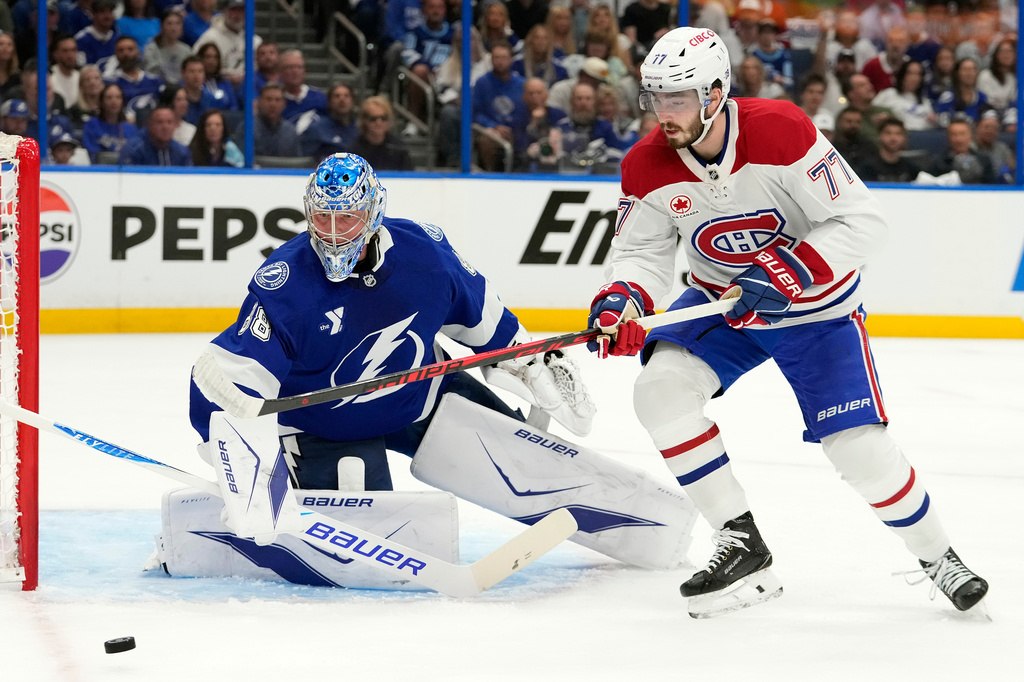 Montréal Canadiens center Kirby Dach (77) plays a loose puck in front of Tampa Bay Lightning goaltender Andrei Vasilevskiy (88) during the first period in Game 5 of an NHL hockey Stanley Cup first-round playoff series, Wednesday, April 29, 2026, in Tampa, Fla. (AP Photo/Chris O'Meara)