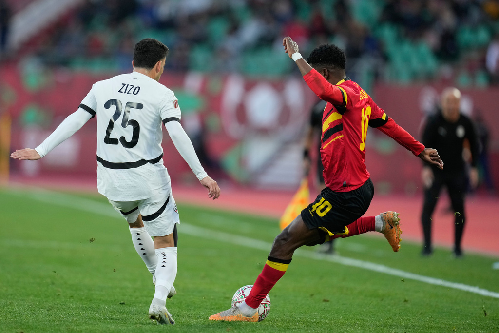 Angola's Gelson Dala, right, kicks the ball during the Africa Cup of Nations group B soccer match between Angola and Egypt in Agadir, Morocco, Monday, Dec. 29, 2025. (AP Photo/Mosa'ab Elshamy)