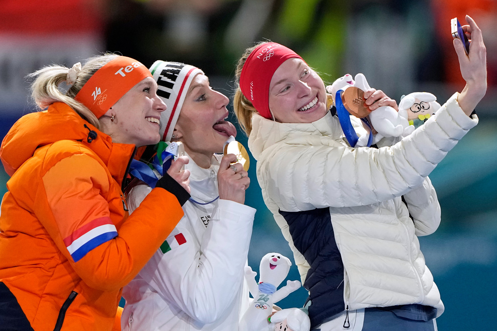 Francesca Lollobrigida of Italy, center and gold medal, Merel Conijn of the Netherlands, left and silver medal, and Ragne Wiklund of Norway, right and bronze medal, celebrate on the podium after the women's 5,000 meters speedskating race at the 2026 Winter Olympics, in Milan, Italy, Thursday, Feb. 12, 2026. (AP Photo/Ben Curtis)