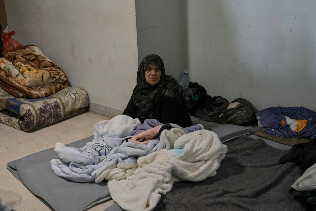 An elderly displaced woman who fled Israeli airstrikes with her family in southern Lebanon sits at the Bir Hassan Technical Institute, which has been turned into a shelter, in Beirut, Lebanon, Wednesday, March 11, 2026. (AP Photo/Bilal Hussein)