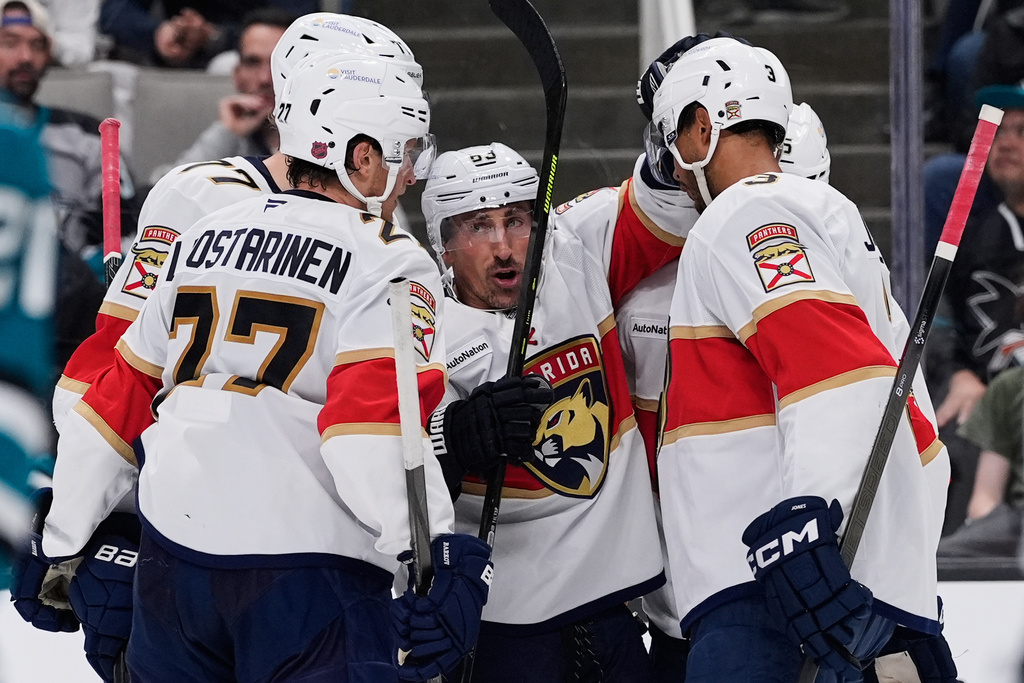 Florida Panthers left wing Brad Marchand, center, celebrates with teammates after scoring a goal during the second period of an NHL hockey game against the San Jose Sharks, Saturday, Nov. 8, 2025, in San Jose, Calif. (AP Photo/Godofredo A. Vásquez)