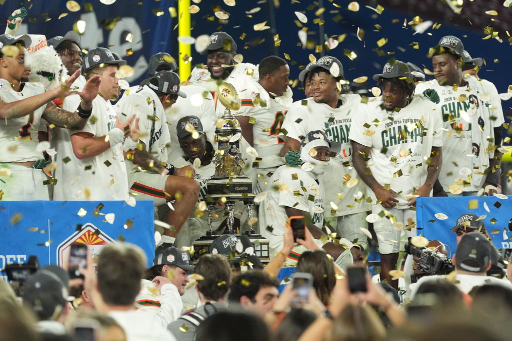 Miami players celebrate after winning the Fiesta Bowl NCAA college football playoff semifinal game against Mississippi, Thursday, Jan. 8, 2026, in Glendale, Ariz. (AP Photo/Ross D. Franklin)