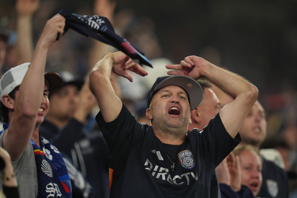 San Diego FC fans chant during the first half of Game 3 in the first round of MLS soccer's Western Conference playoffs against the Portland Timbers Sunday, Nov. 9, 2025, in San Diego. (AP Photo/Gregory Bull)