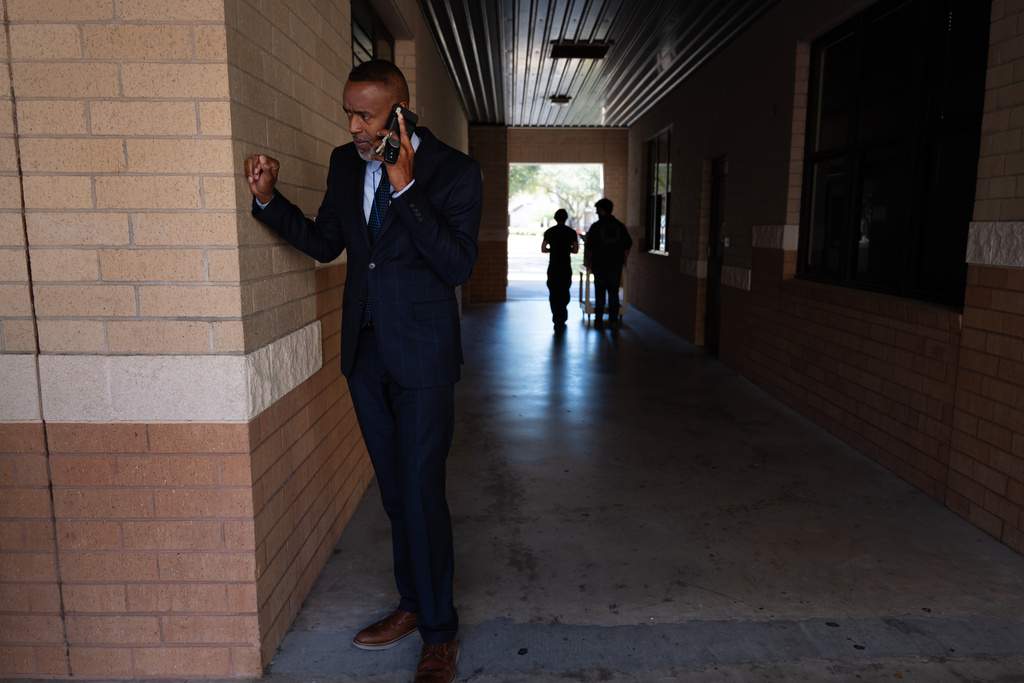 Lackland Independent School District Superintendent Dr. Burnie Roper makes a call while walking around the school campus Monday, Nov. 3, 2025, in San Antonio. (AP Photo/Kin Man Hui)
