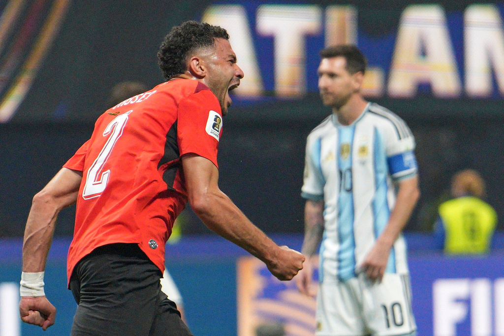 Egypt's Yasser Ibrahim (2) celebrates after scoring the opening goal as Argentina's Lionel Messi (10) looks on during the World Cup round of 16 soccer match between Argentina and Egypt in Atlanta, Tuesday, July 7, 2026. (AP Photo/Jacob Kupferman)