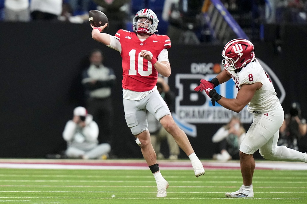 Ohio State's Julian Sayin throws against Indiana's Stephen Daley during the second half of the Big Ten championship NCAA college football game in Indianapolis, Saturday, Dec. 6, 2025. (AP Photo/AJ Mast)