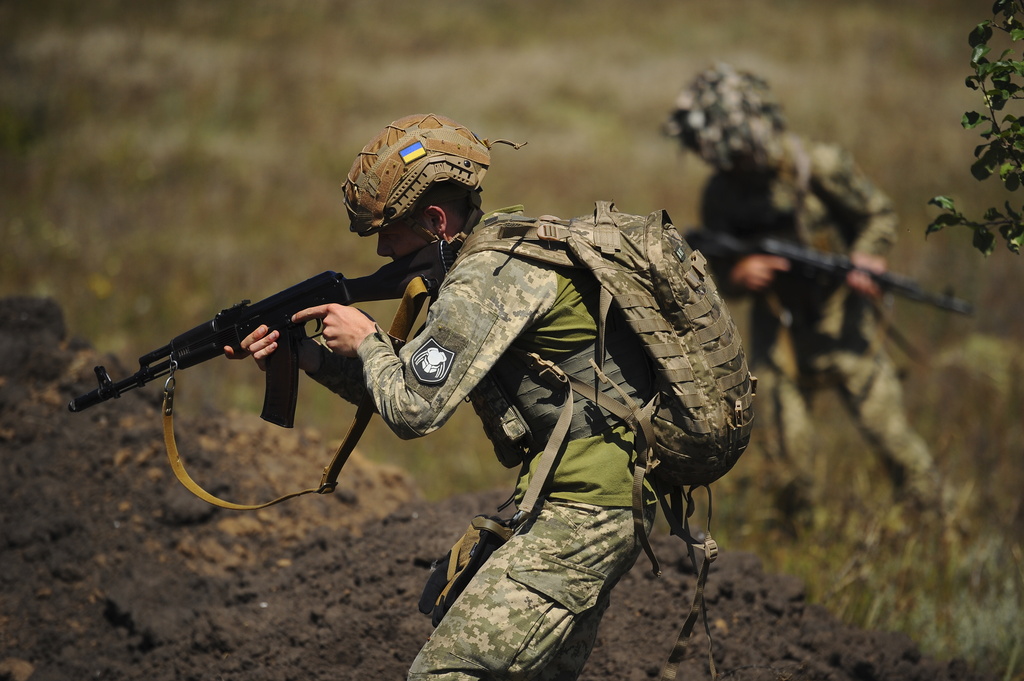In this photo, taken on Tuesday, Aug. 19, 2025 and provided by Ukraine's 127th Separate Brigade of the Territorial Defence press service, soldiers aged 18 to 24 practice military skills on a training ground near Kharkiv, Ukraine. (Anatolii Lysianskyi/Ukraine's 127th Separate Brigade via AP)