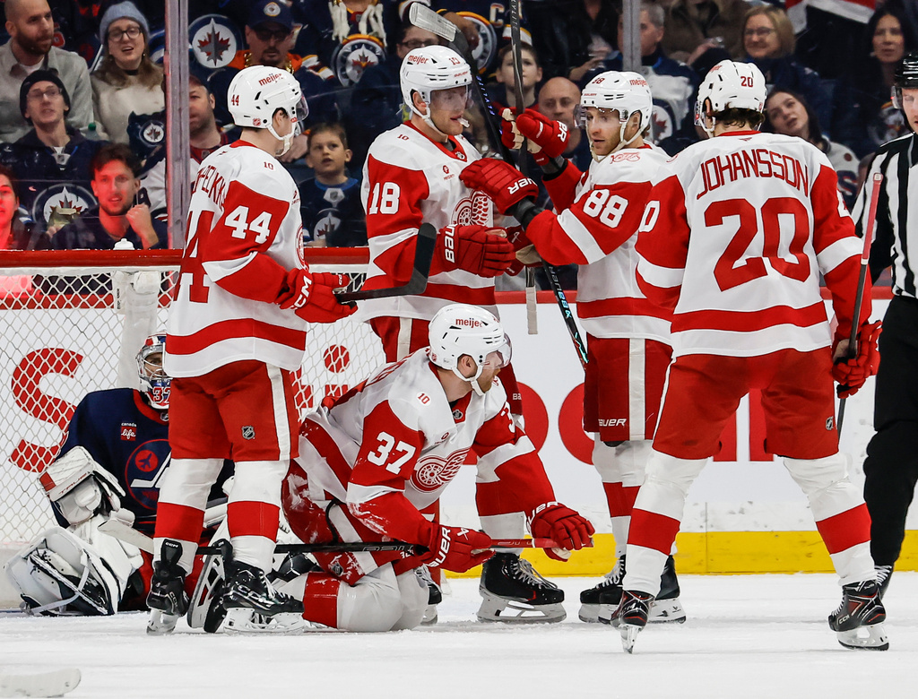 Detroit Red Wings' J.T. Compher (37) celebrates after he scored against the Winnipeg Jets during second-period NHL hockey game action in Winnipeg, Manitoba, Saturday, Jan. 24, 2026. (John Woods/The Canadian Press via AP)