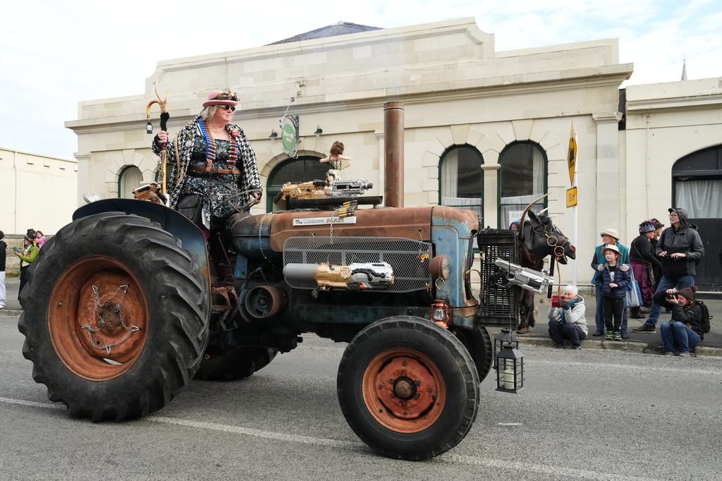 A participant rides a tractor during a parade at the Steampunk NZ Festival in Ōamaru, New Zealand, on May 30, 2026. (AP Photo/Charlotte Graham-McLay)