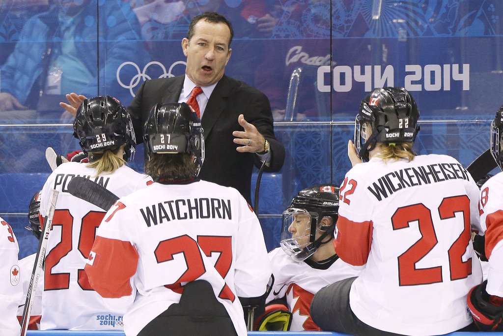 FILE - Canada head coach Kevin Dineen talks to his team during a break in the action against Switzerland in the first period of the 2014 Winter Olympics women's semifinal ice hockey game at Shayba Arena, Feb. 17, 2014, in Sochi, Russia. (AP Photo/Mark Humphrey, File)