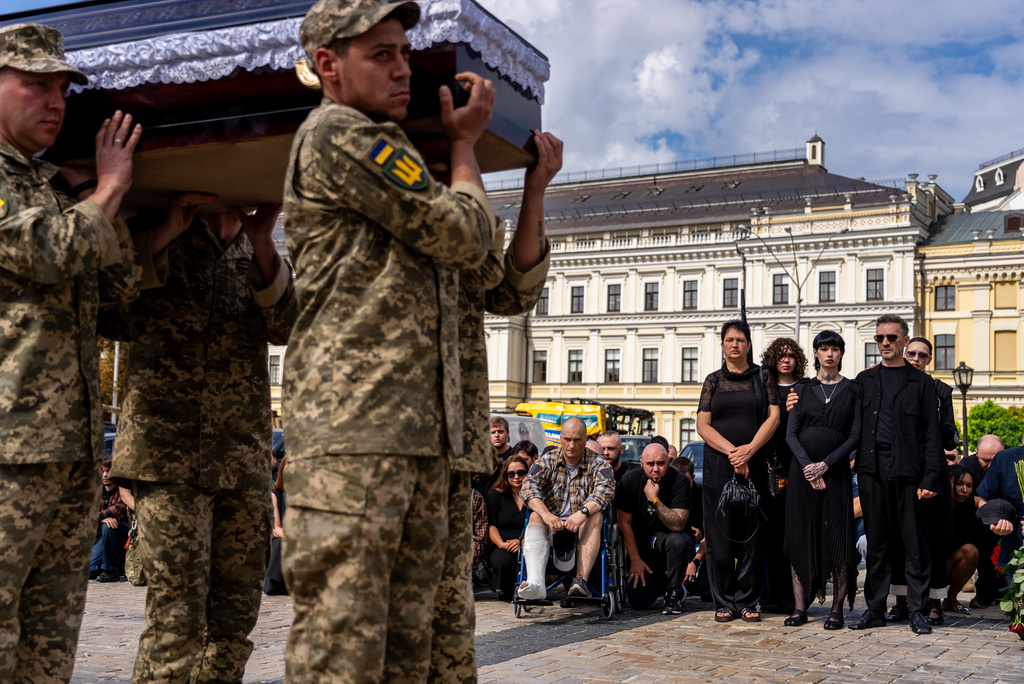 Family and friends pay their respects to soldier Danyil Smyrnov, 21, who was killed on the frontline, during his funeral ceremony in Kyiv, Ukraine, Thursday, Sept. 3, 2026. (AP Photo/Alex Babenko)
