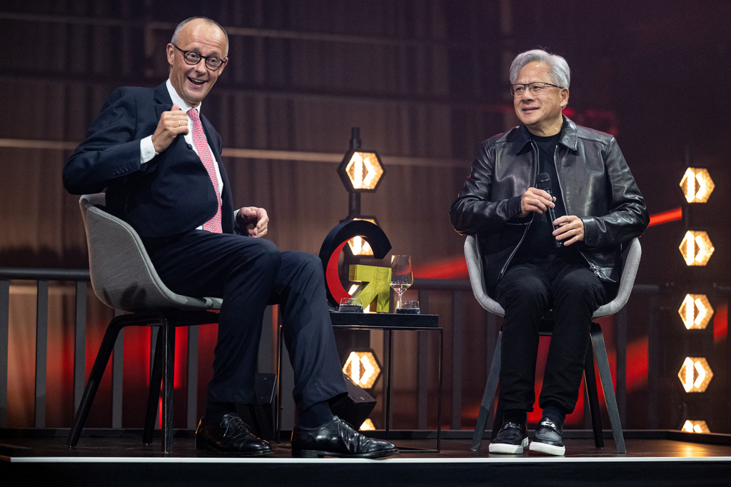 German Chancellor Friedrich Merz, left, and Nvidia CEO Jensen Huang, attend the opening ceremony of the "Invest in Germany Summit" in Berlin, Monday, Oct. 19, 2026. (Fabian Sommer/dpa via AP)