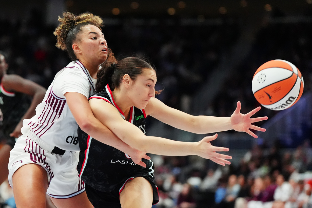 Toronto Tempo's Kiki Rice, left, and Portland Fire's Carla Leite, right, battle for the ball during second-half WNBA basketball game action in Toronto, Saturday May 23, 2026. (Frank Gunn/The Canadian Press via AP)