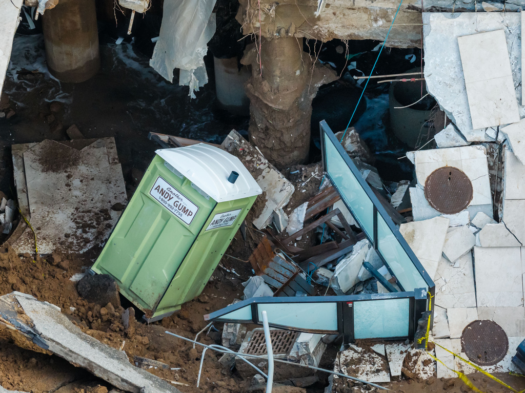 An aerial view of a sinkhole which collapsed the driveway of a coastal mansion owned by actor Nicolas Cage Tuesday, Sept. 8, 2026, in Malibu, Calif. (AP Photo/Ethan Swope)