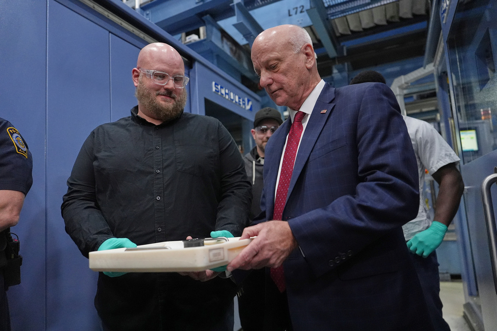 U.S. Treasurer Brandon Beach and Christopher Faulls hold some the last pennies to be pressed at the U.S. Mint in Philadelphia, Wednesday, Nov. 12, 2025. (AP Photo/Matt Slocum)