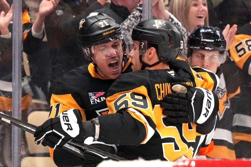 Pittsburgh Penguins' Egor Chinakhov (59) celebrates with Evgeni Malkin (71) after scoring during the second period of an NHL hockey game against the Calgary Flames in Pittsburgh, Saturday, Jan. 10, 2026. (AP Photo/Gene J. Puskar)