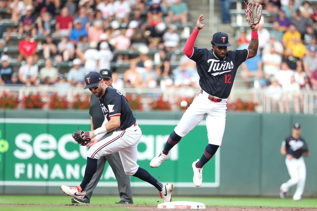 Minnesota Twins second baseman Kody Clemens and shortstop Kaelen Culpepper are unable to field the ball hit by Baltimore Orioles' Yohel Pozo during the first inning of a baseball game, Tuesday, Aug. 11, 2026, in Minneapolis. (AP Photo/Matt Krohn)