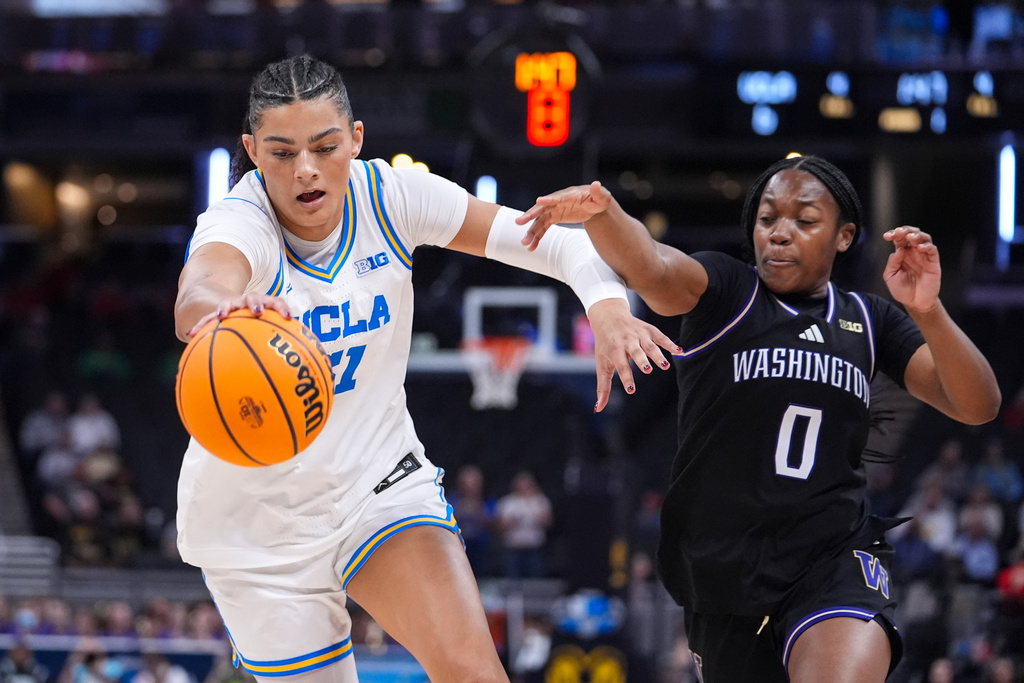 UCLA center Lauren Betts (51) steals the ball from Washington guard Sayvia Sellers (0) in the first half of an NCAA college basketball game in the quarterfinals of the Big Ten Conference tournament, Friday, March 6, 2026 in Indianapolis. (AP Photo/Michael Conroy)
