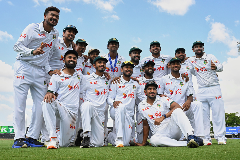 Bangladesh players pose for a team photo as they celebrate after defeating Australia on day four of the first cricket test in Darwin, Australia, Sunday, Aug. 16, 2026. (James Ross/AAP Image via AP)