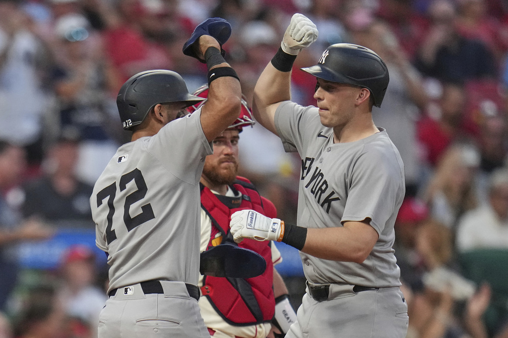 New York Yankees' Ben Rice, right, is congratulated by teammate Jose Caballero (72) after hitting a three-run home run as St. Louis Cardinals catcher Pedro Pages, center, watches during the fourth inning of a baseball game Saturday, Aug. 16, 2025, in St. Louis. (AP Photo/Jeff Roberson)