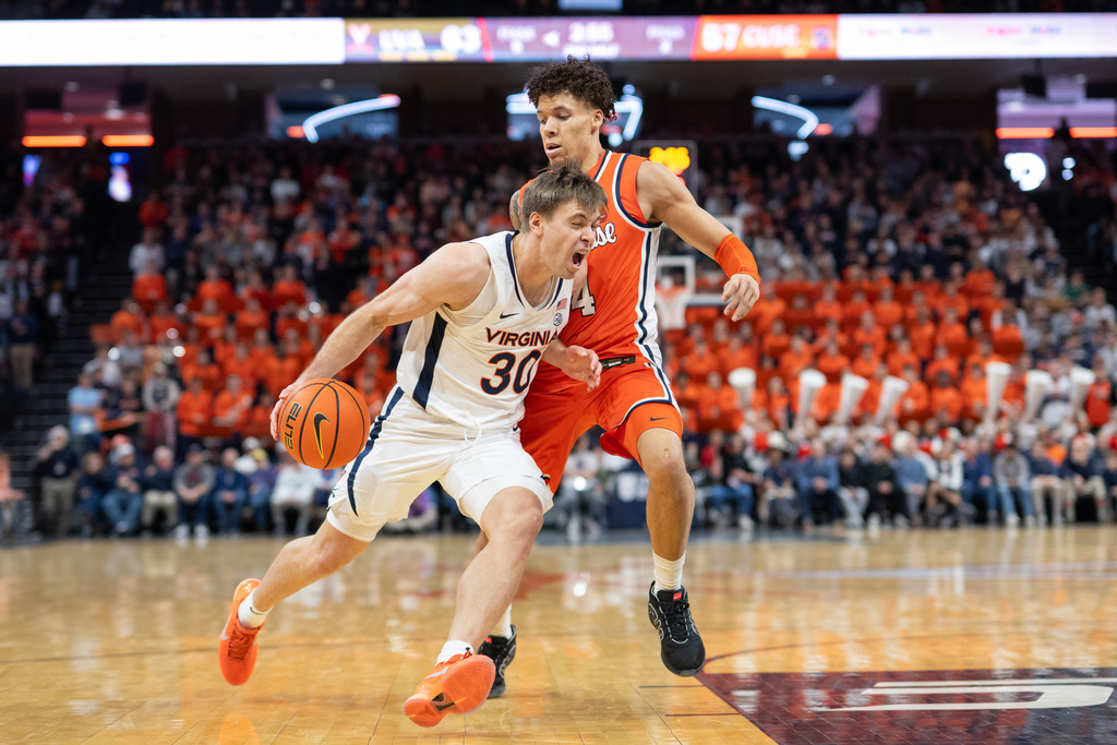Virginia guard Dallin Hall (30) drives by Syracuse guard Nate Kingz (4) during the second half of an NCAA college basketball game, Saturday, Feb. 7, 2026, in Charlottesville, Va. (AP Photo/Robert Simmons)