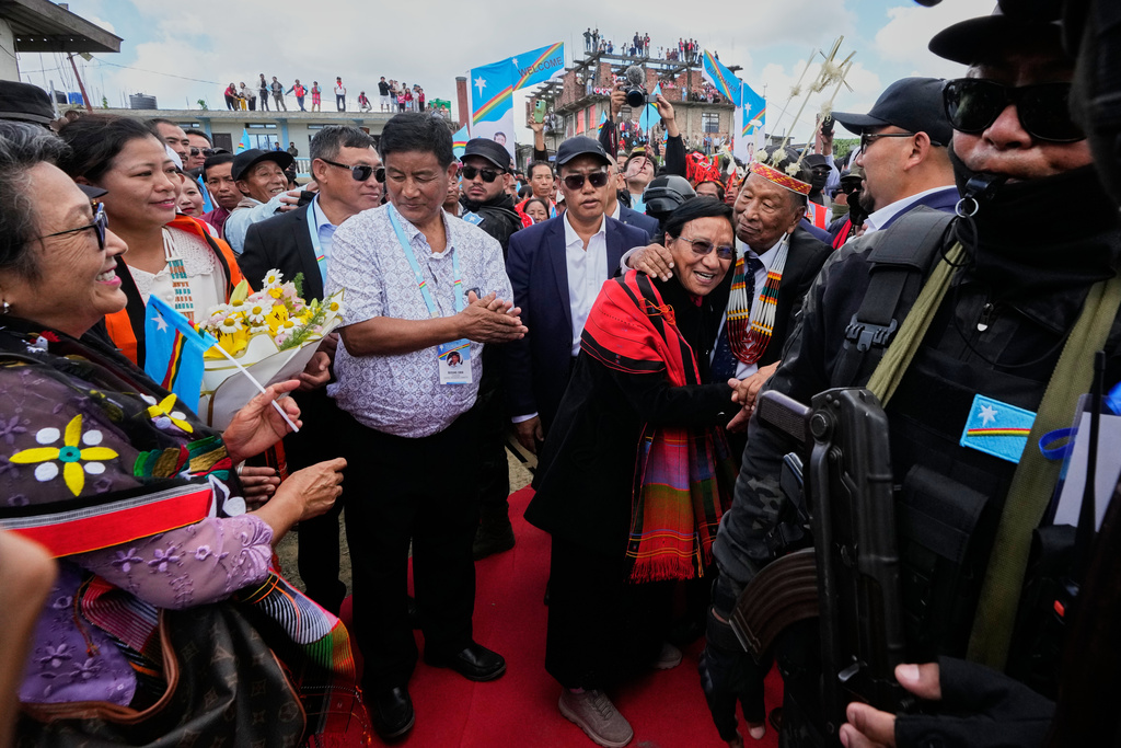 Thuingaleng Muivah, leader of the National Socialist Council of Nagaland (Isak-Muivah), embraces his wife upon arrival in Ukhrul, in the northeastern Indian state of Manipur, Wednesday, Oct. 22, 2025. (AP Photo/Anupam Nath)