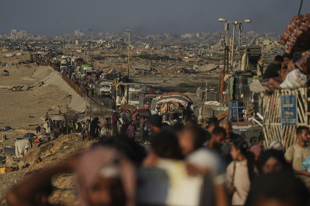 Displaced Palestinians flee northern Gaza by foot and in vehicles, carrying their belongings along the coastal road toward southern Gaza, Sunday, Sept. 14, 2025. (AP Photo/Abdel Kareem Hana)