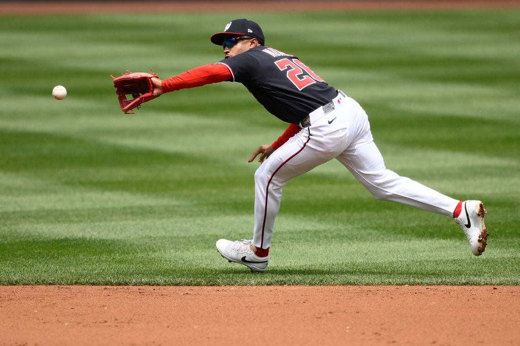 Washington Nationals second baseman Nasim Nuñez (26) fields a ball hit for a single by Minnesota Twins' Luke Keaschall during the second inning of a baseball game, Thursday, May 7, 2026, in Washington. (AP Photo/Nick Wass)