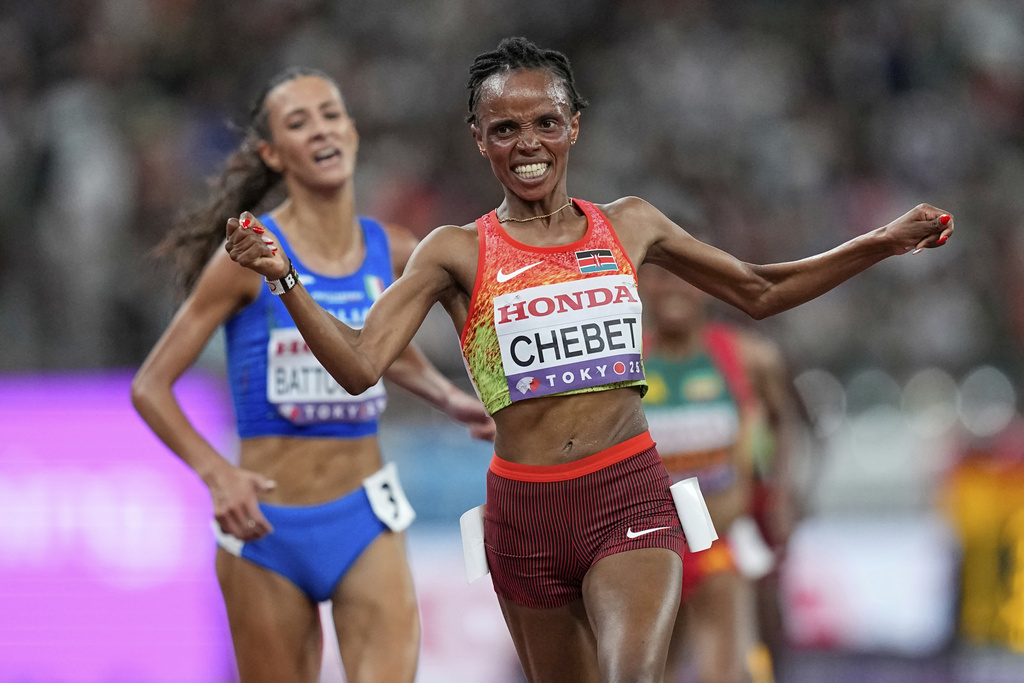 Kenya's Beatrice Chebet crosses the line to win the gold medal in the women's 10,000 meters final at the World Athletics Championships in Tokyo, Saturday, Sept. 13, 2025. (AP Photo/Petr David Josek)