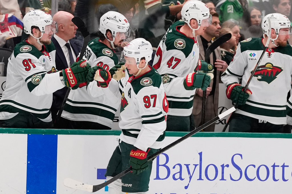 Minnesota Wild left wing Kirill Kaprizov (97) celebrates with the team after scoring against the Dallas Stars in the first period of an NHL hockey game Thursday, April 9, 2026, in Arlington, Texas. (AP Photo/Tony Gutierrez)