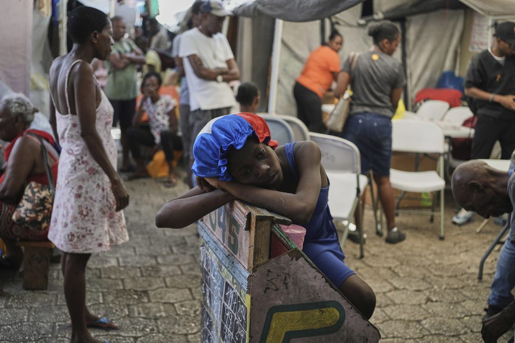 A girl rests at a shelter for families displaced by gang violence in Port-au-Prince, Haiti, Wednesday, Aug. 12, 2026. (AP Photo/Odelyn Joseph)