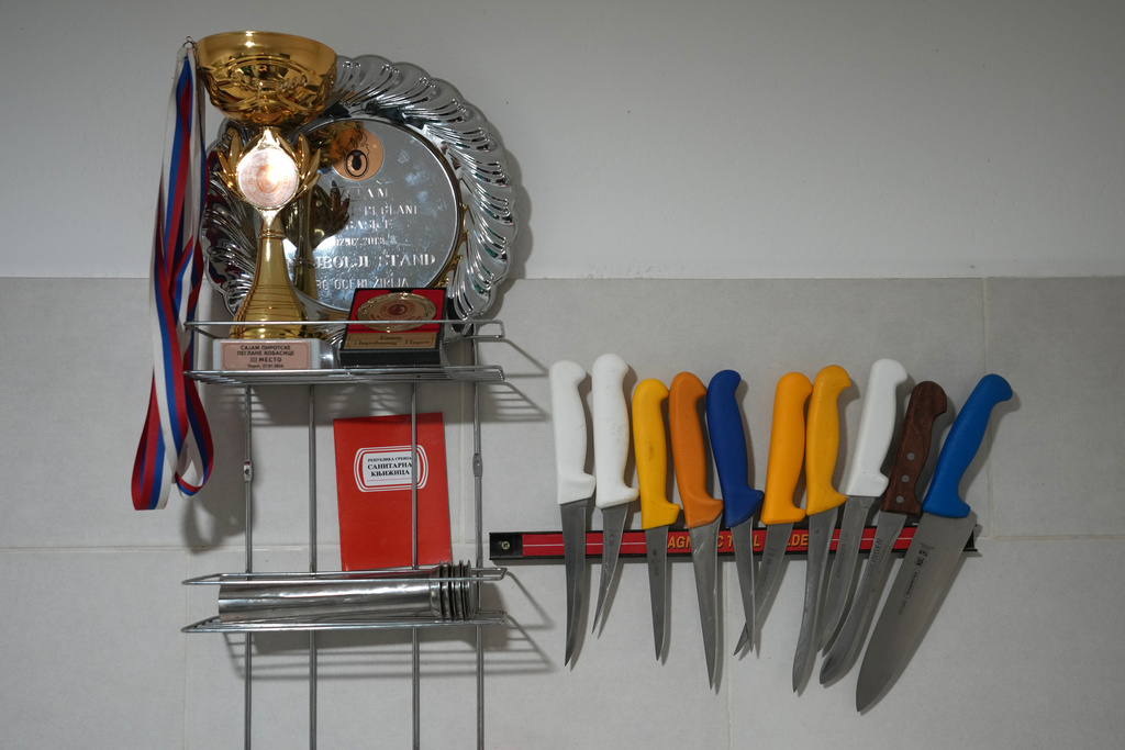 Knives, medals and trophies are seen in Misa Rajic's home in Pirot, Serbia, on Feb. 13, 2026. (AP Photo/Darko Vojinovic)