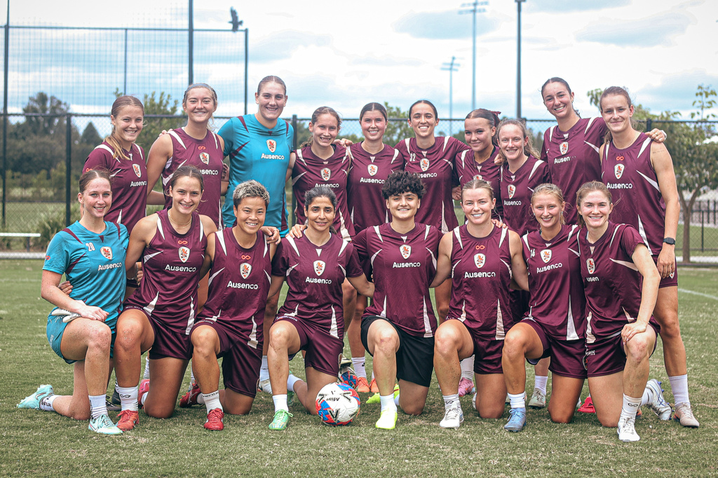 Iranian soccer player's Fatemeh Pasandideh, fourth from right at front row, and Atefeh Ramezanisadeh, fourth from left at front row, pose for a photo with the Brisbane Roar women's A-League team at a training session in Brisbane, Australia, Monday, March 16, 2026. (Brisbane Roar via AP)