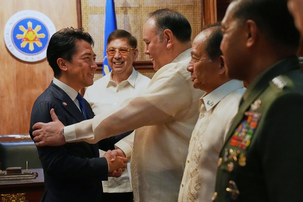 Philippine Defense Secretary Gilbert Teodoro Jr. greets his counterpart Japan's Shinjiro Koizumi, left, at the Malacanang presidential palace in Manila, Philippines on Tuesday, May 5, 2026. (AP Photo/Aaron Favila, Pool)