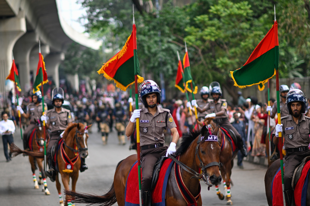 Horse-mounted policemen participate in the Baishakhi Shobhajatra procession to celebrate the first day of the Bangla New Year in Dhaka, Bangladesh, Tuesday, April 14, 2026. (AP Photo/Mahmud Hossain Opu)