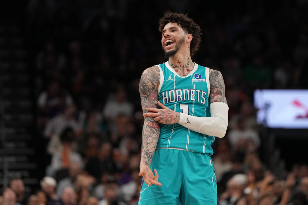 Charlotte Hornets guard LaMelo Ball reacts towards a fan after scoring against the Phoenix Suns during the second half of an NBA basketball game, Sunday, March 8, 2026, in Phoenix. (AP Photo/Rick Scuteri)