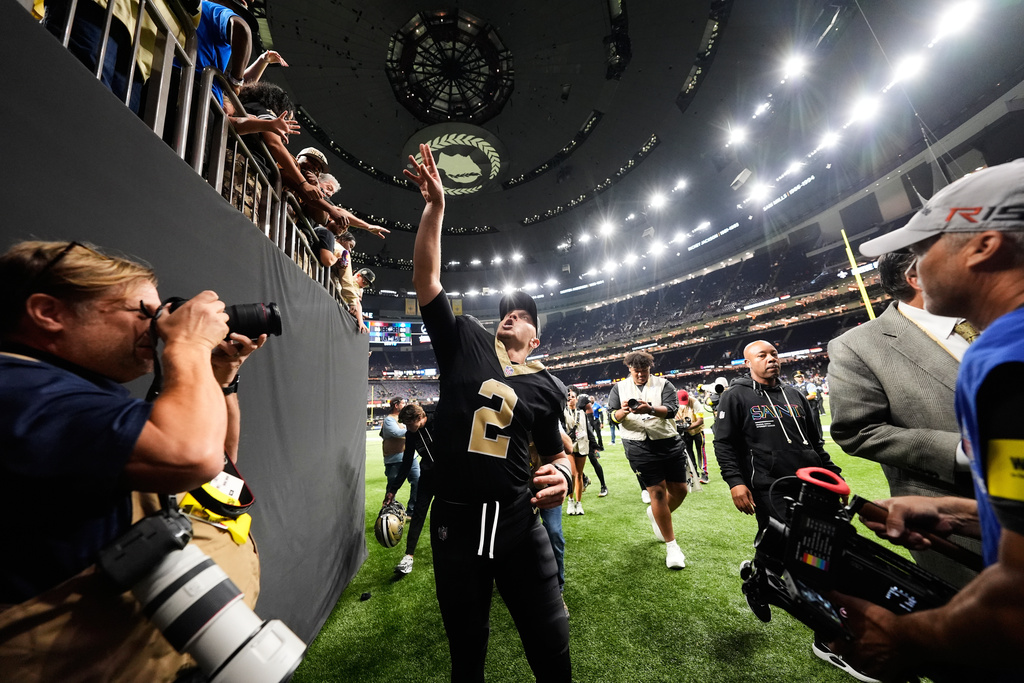New Orleans Saints quarterback Spencer Rattler (2) tosses a town to fans after an NFL football game against the New York Giants in New Orleans, Sunday, Oct. 5, 2025. (AP Photo/Gerald Herbert)
