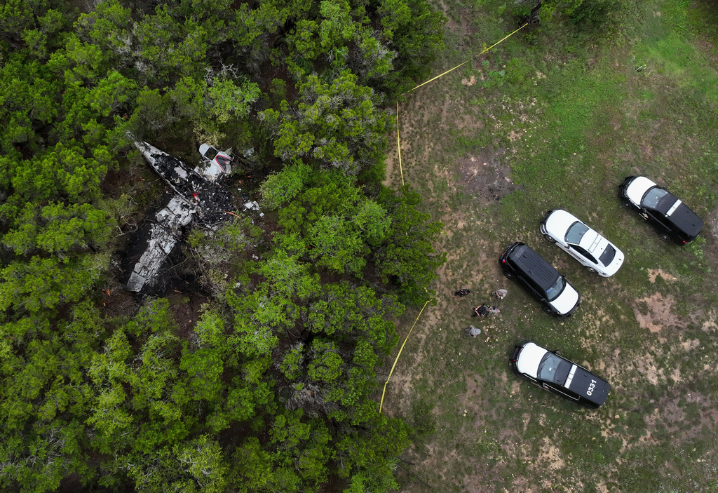 A crashed Cessna airplane is seen in a wooded area on Round Rock Road in Wimberley, Texas, Friday, May 1, 2026. (Jay Janner/Austin American-Statesman via AP)